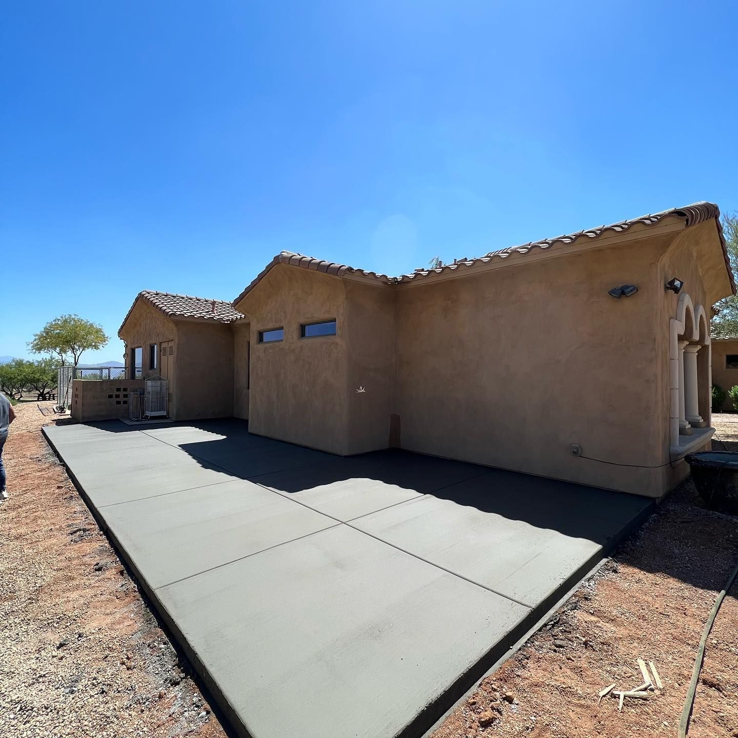 A house with a concrete driveway in front of it