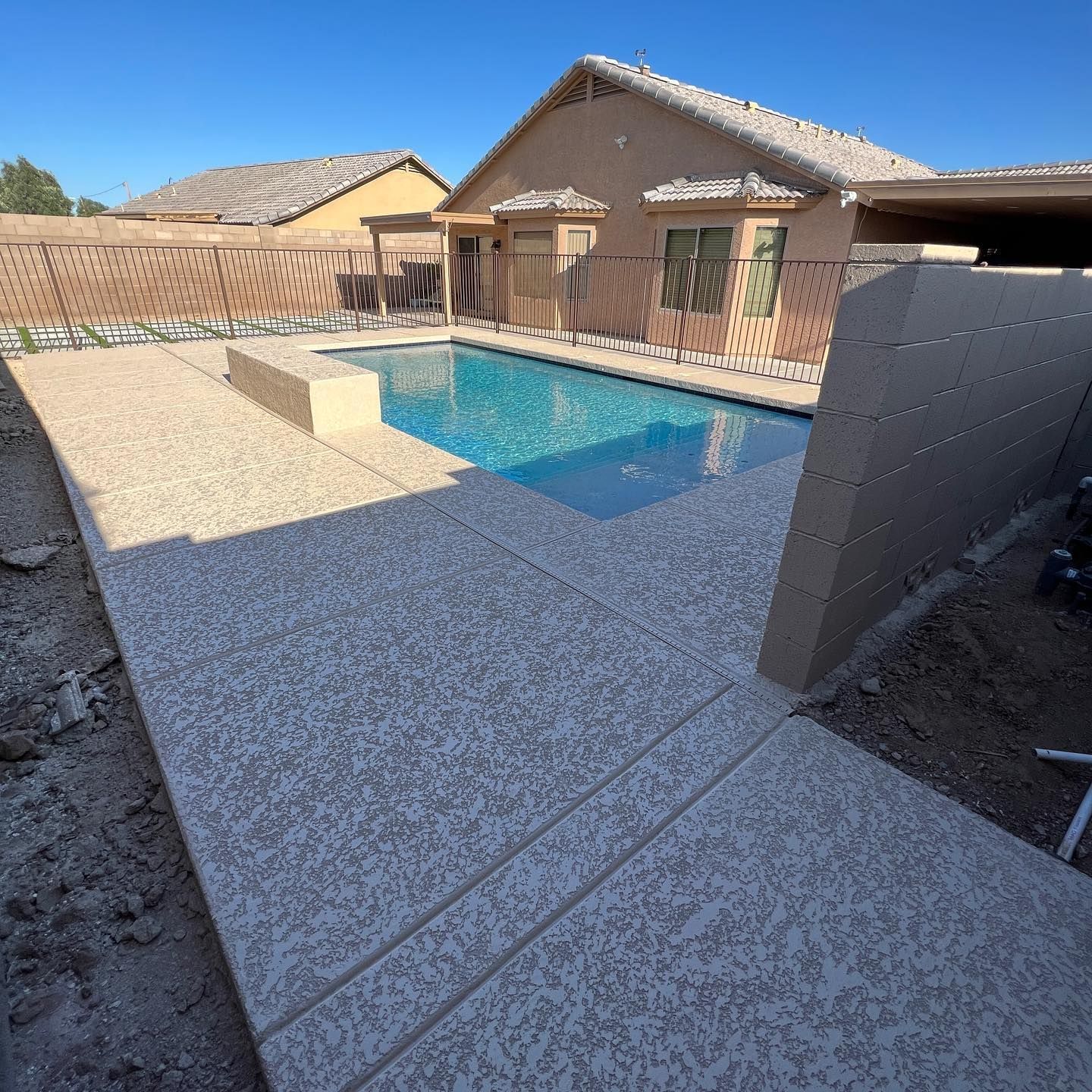 A house with a large swimming pool in front of it