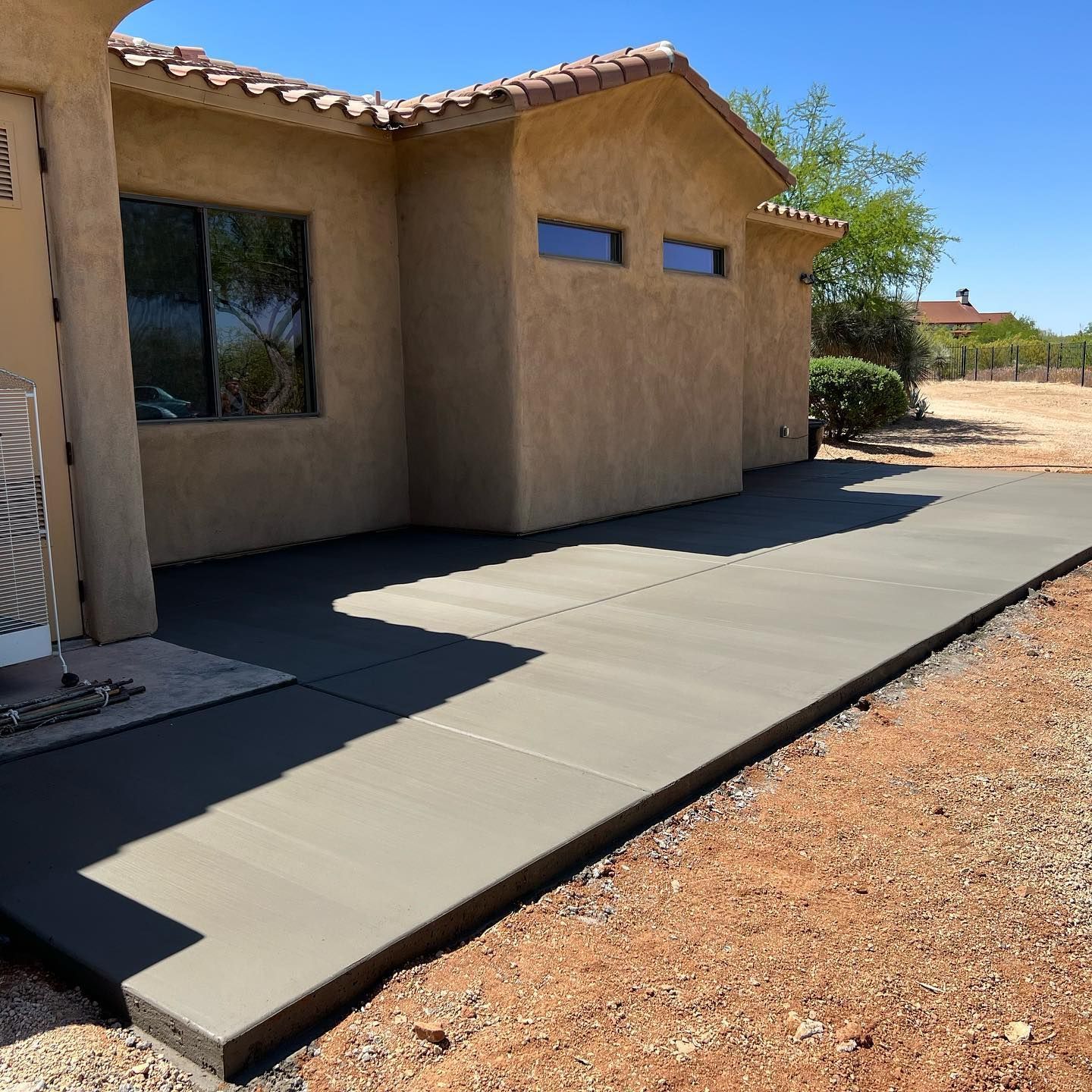 A concrete walkway is being built in front of a house.