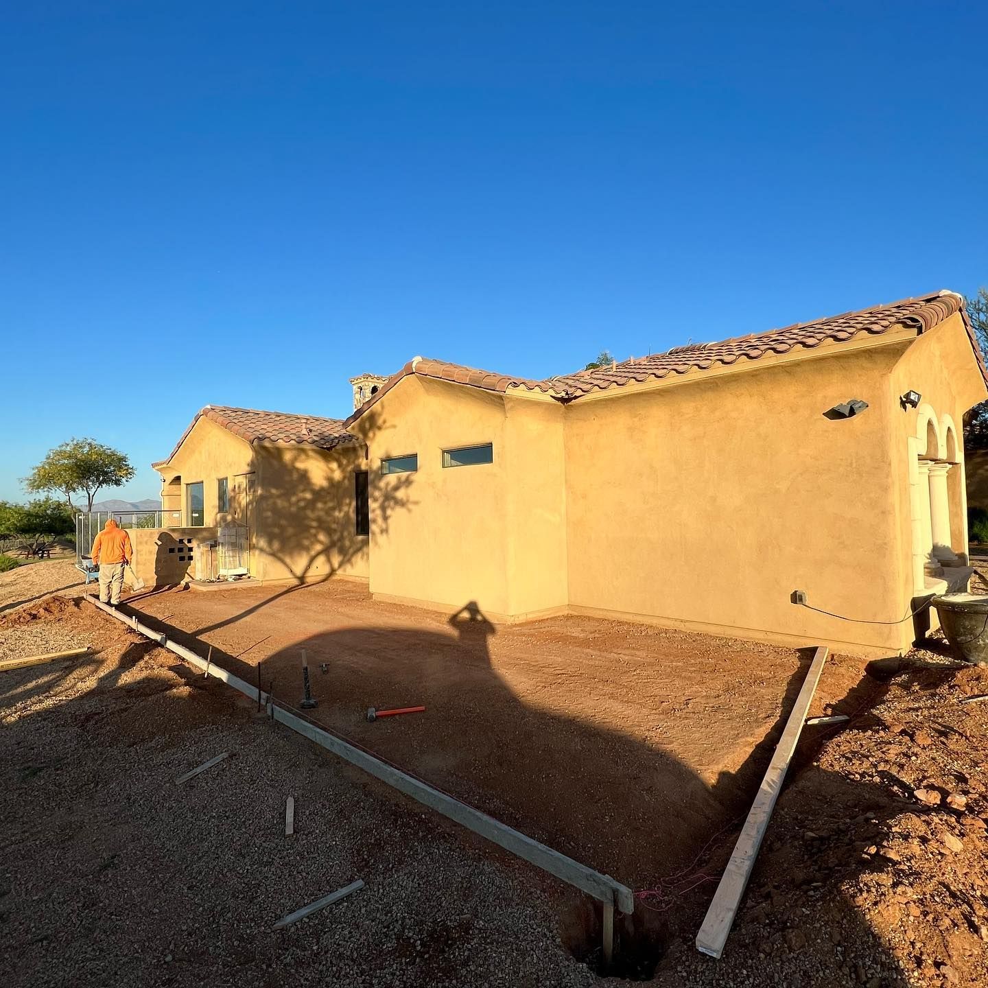 A house that is being built with a lot of dirt in front of it