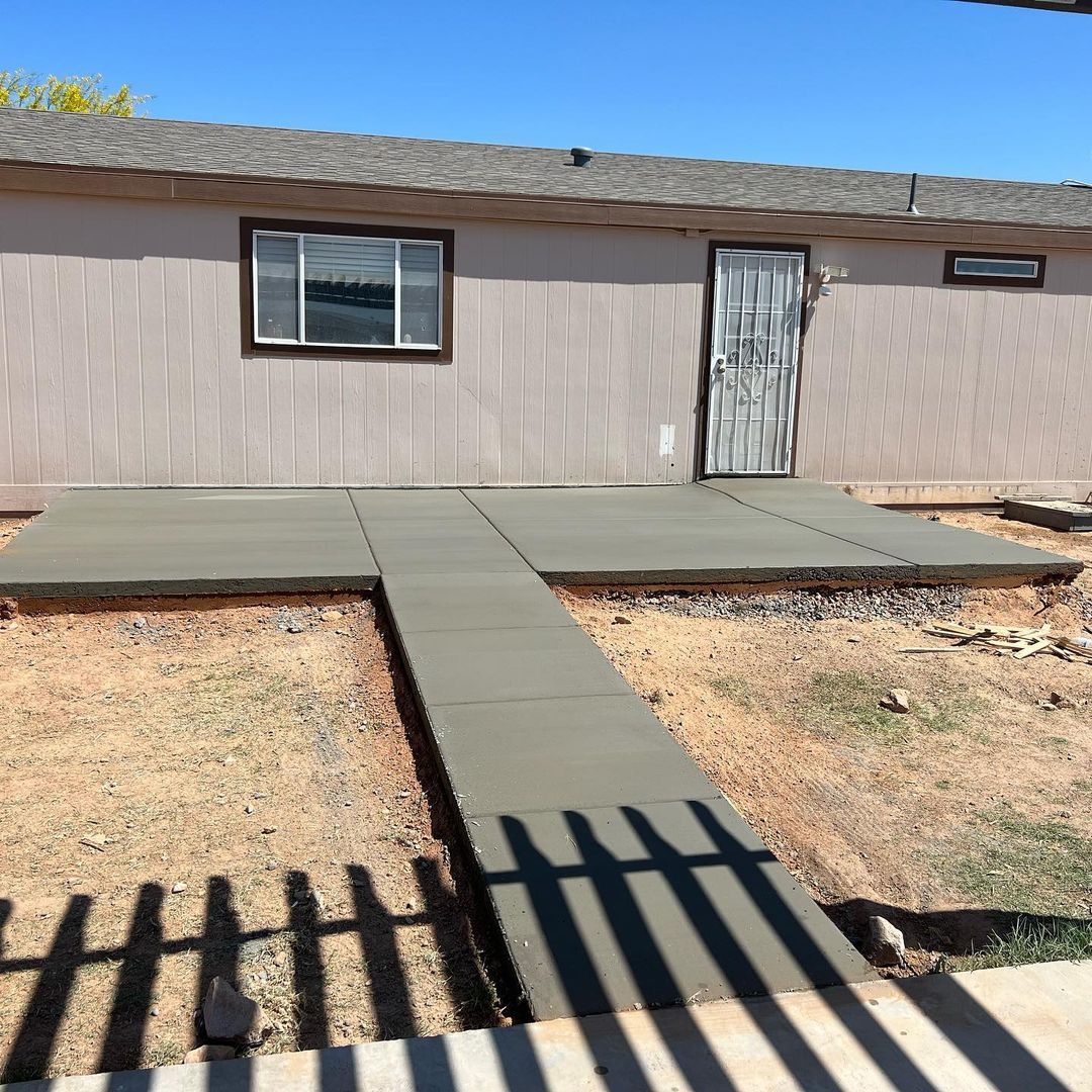 A house with a concrete walkway leading to it