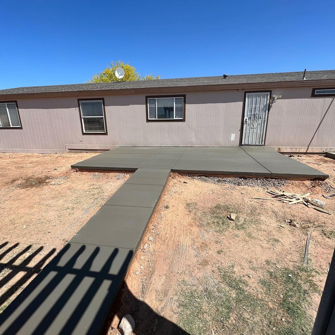 A house with a concrete walkway leading to it