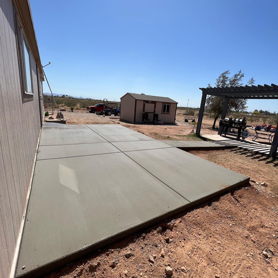 A concrete walkway is being built in front of a house