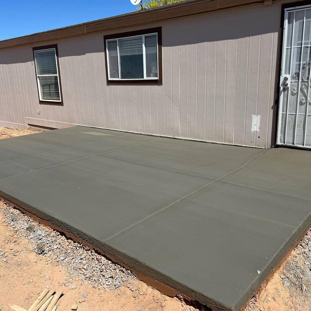 A house with a concrete patio in front of it