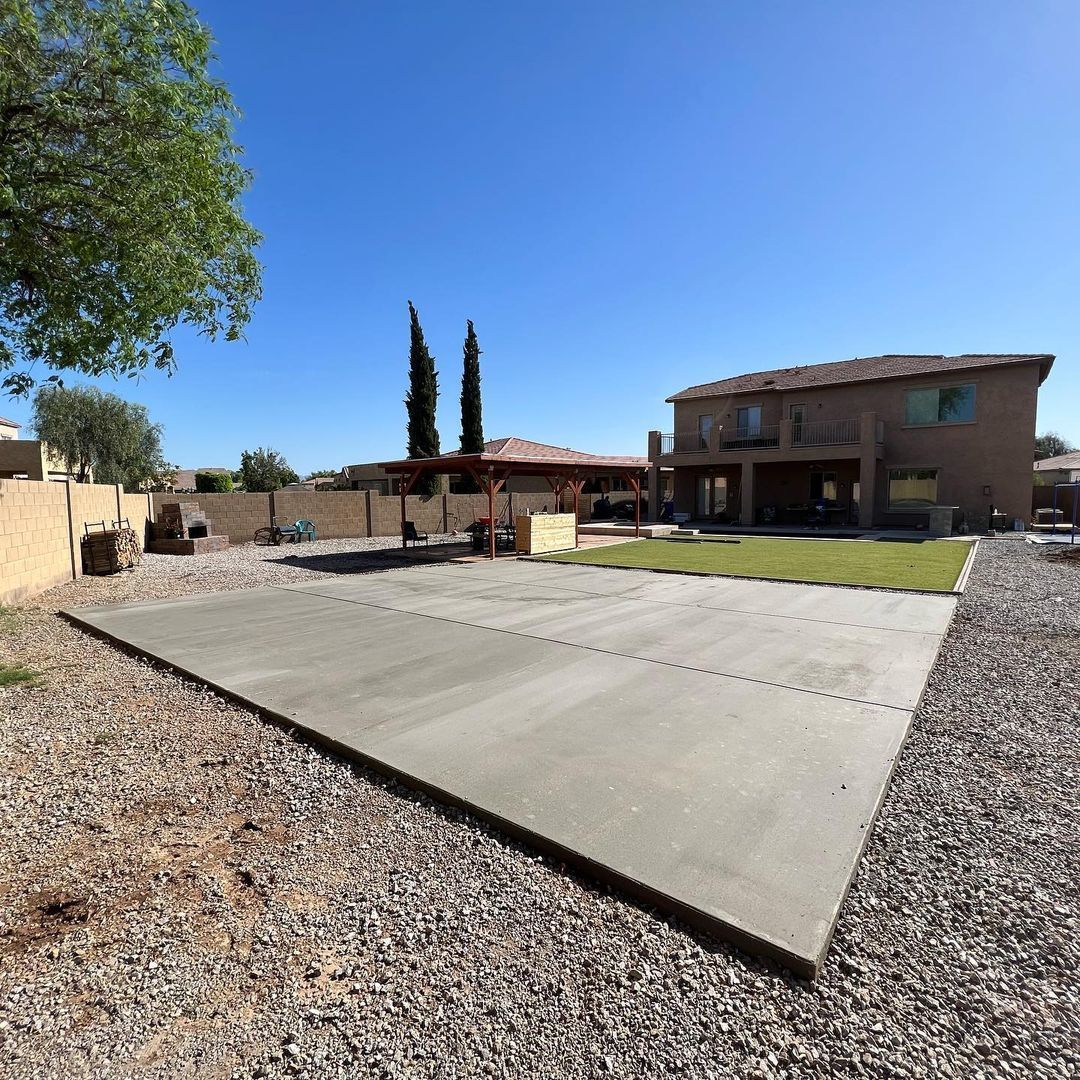 A large house with a concrete driveway in front of it