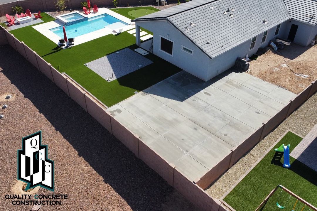 An aerial view of a house with a pool in the backyard