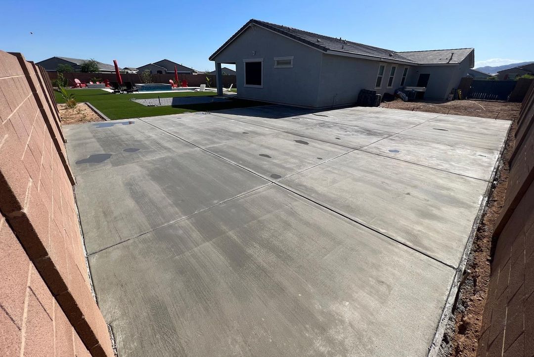 A concrete driveway is being built in front of a house.