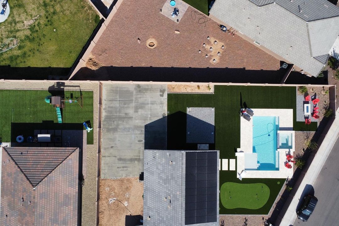 An aerial view of a house with a pool in the backyard