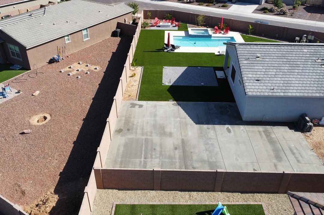 An aerial view of a house with a pool in the backyard.