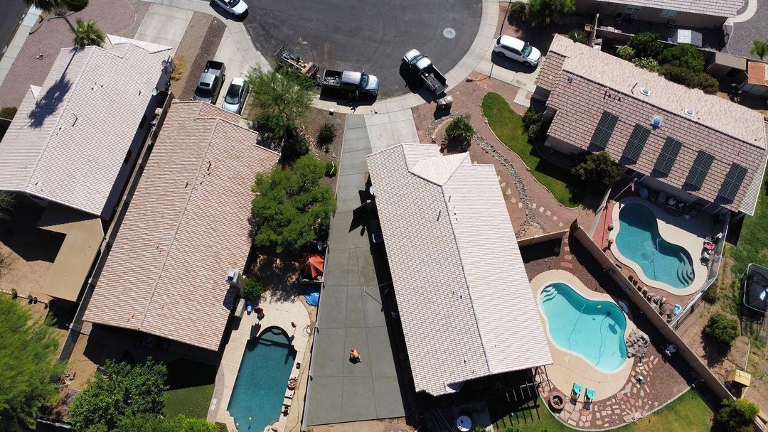 An aerial view of a residential area with houses and pools
