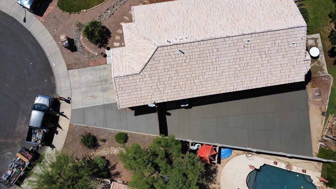 An aerial view of a house with a pool and a car parked in front of it.