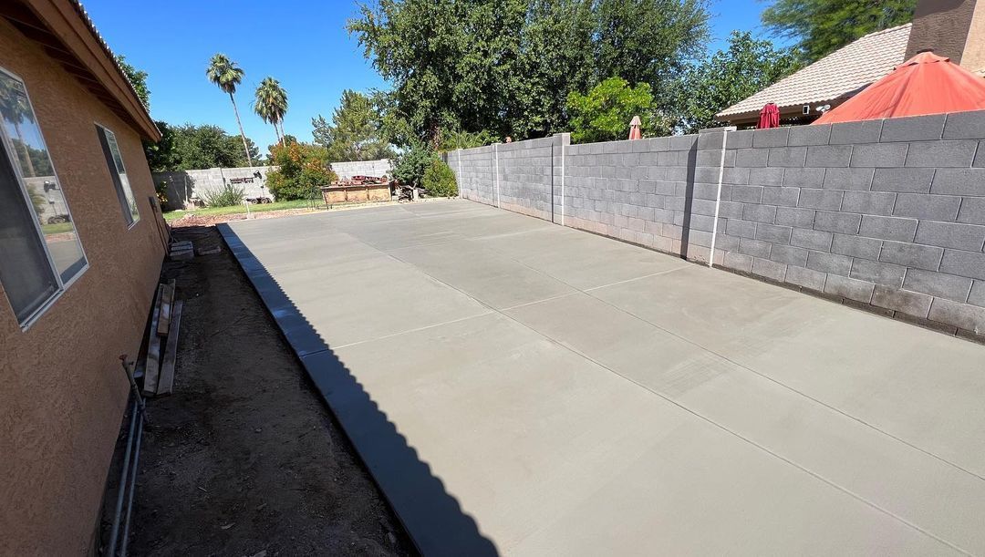A concrete driveway is being built in front of a house.