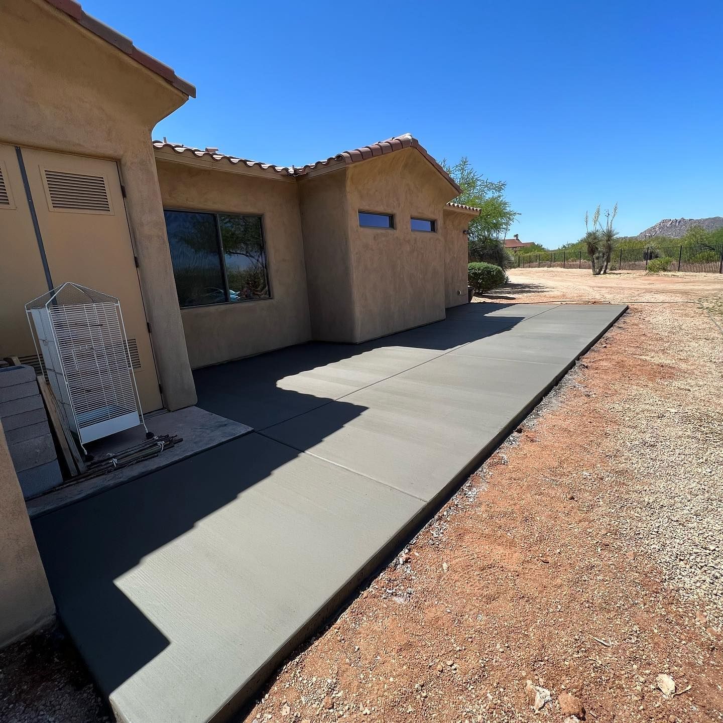 A house with a concrete walkway in front of it