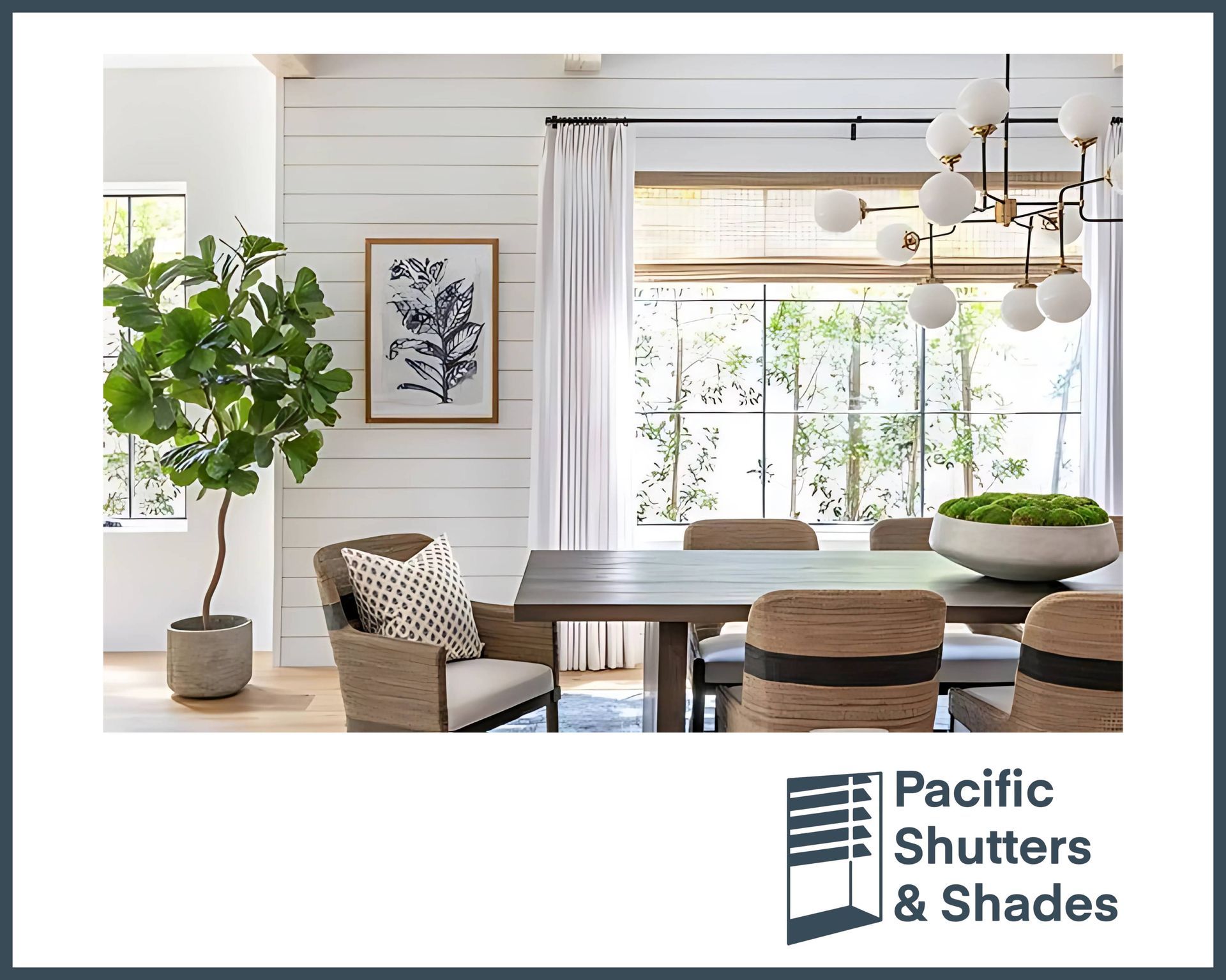 Dining room with neutral color palette. Table, chairs, woven shades, artwork, and large plant.