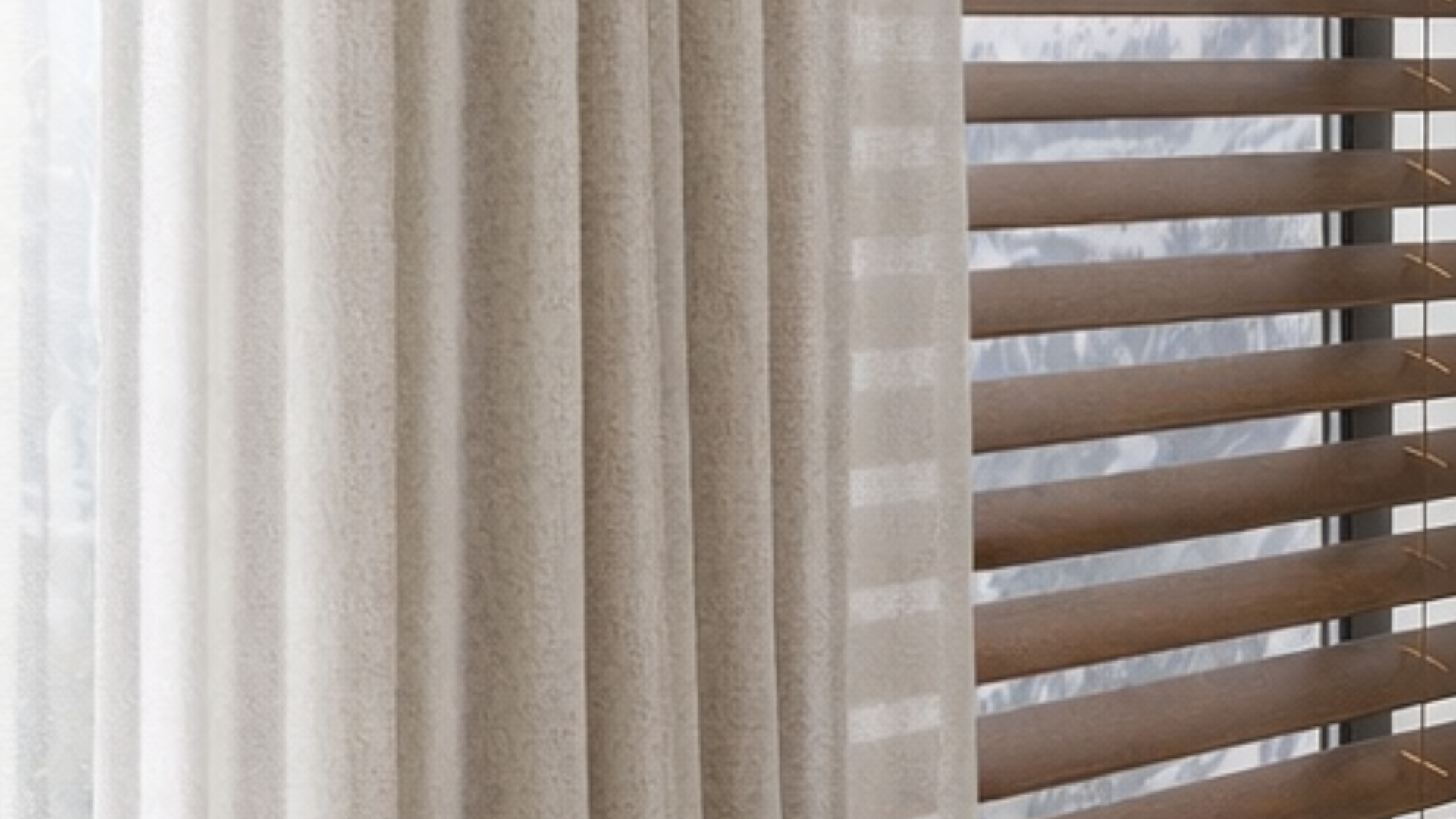 Hunter Douglas Parkland® Wood Blinds and custom drapery in a living room near Carlsbad, CA.