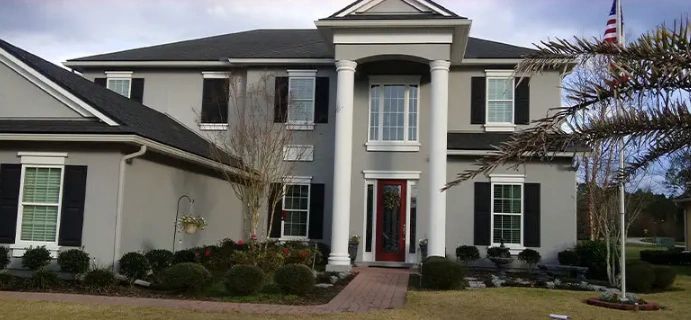 A large house with a flag in front of it.
