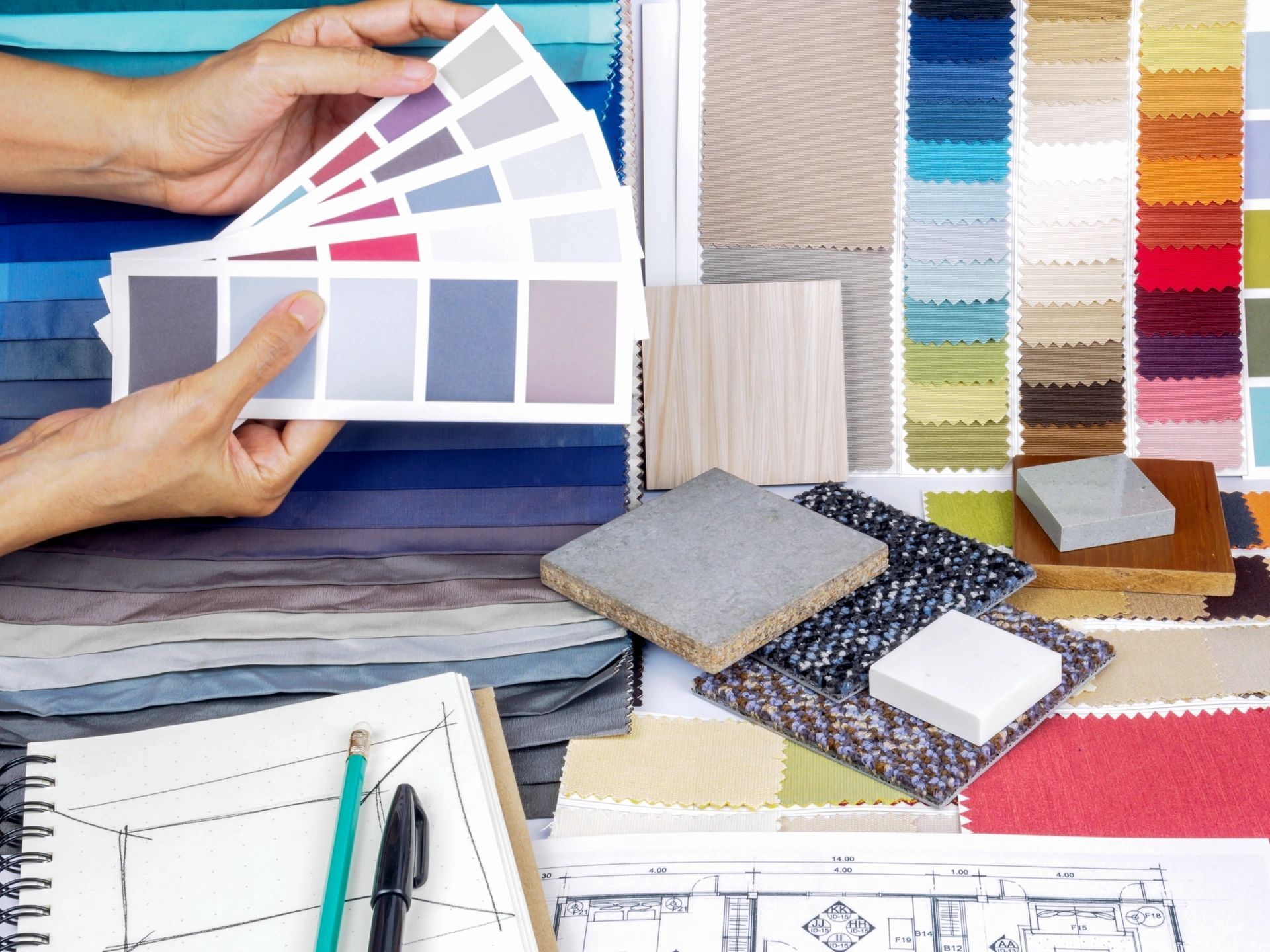 A person is holding a palette of colors in their hands.