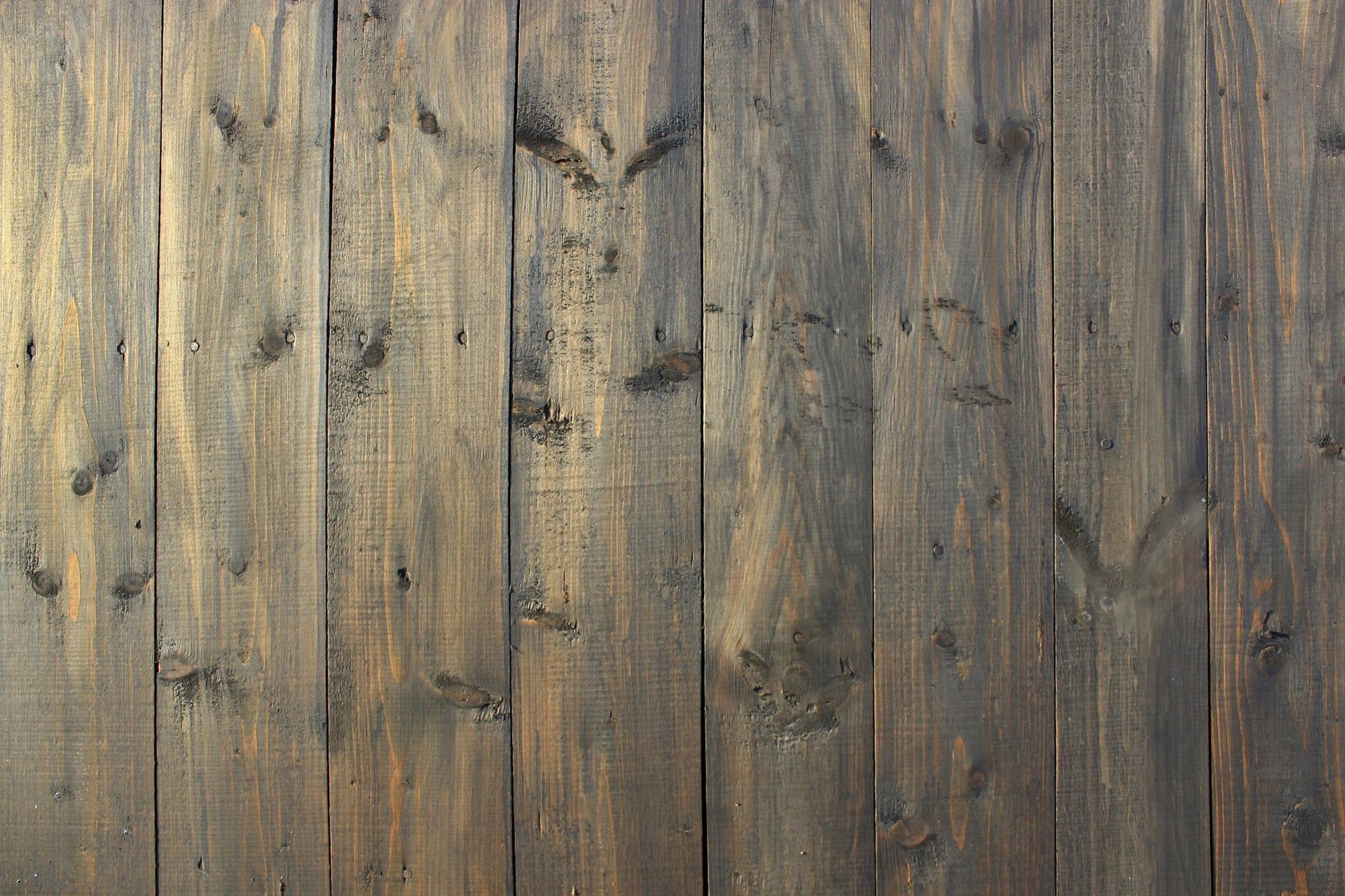 A close up of a wooden fence with a grainy texture.
