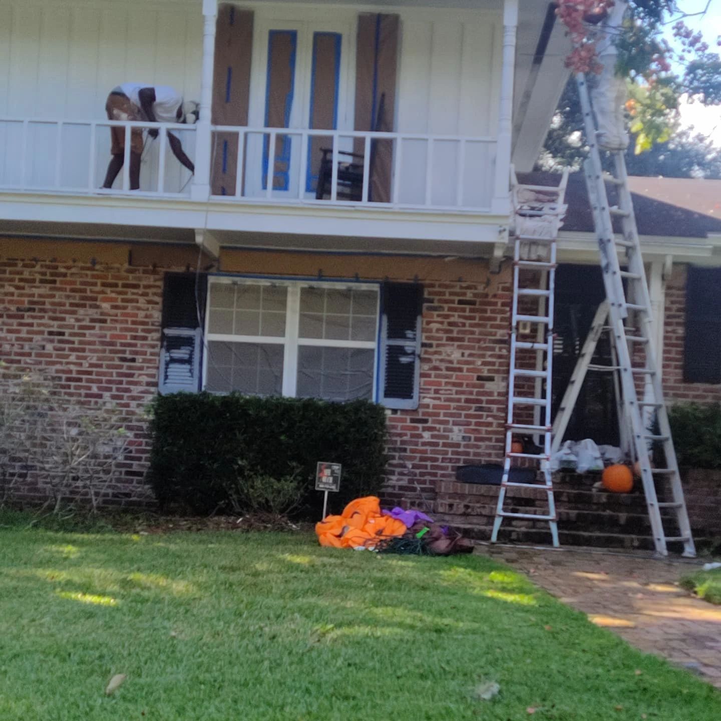 A brick house with a ladder in front of it