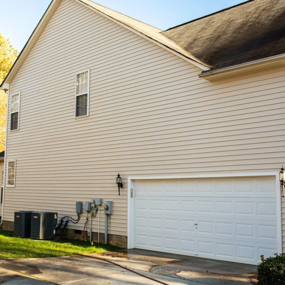 A large white house with a white garage door