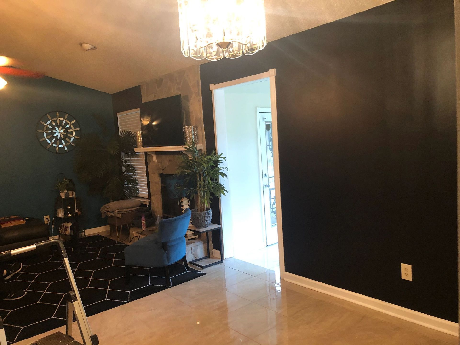 A living room with black walls and a fireplace.