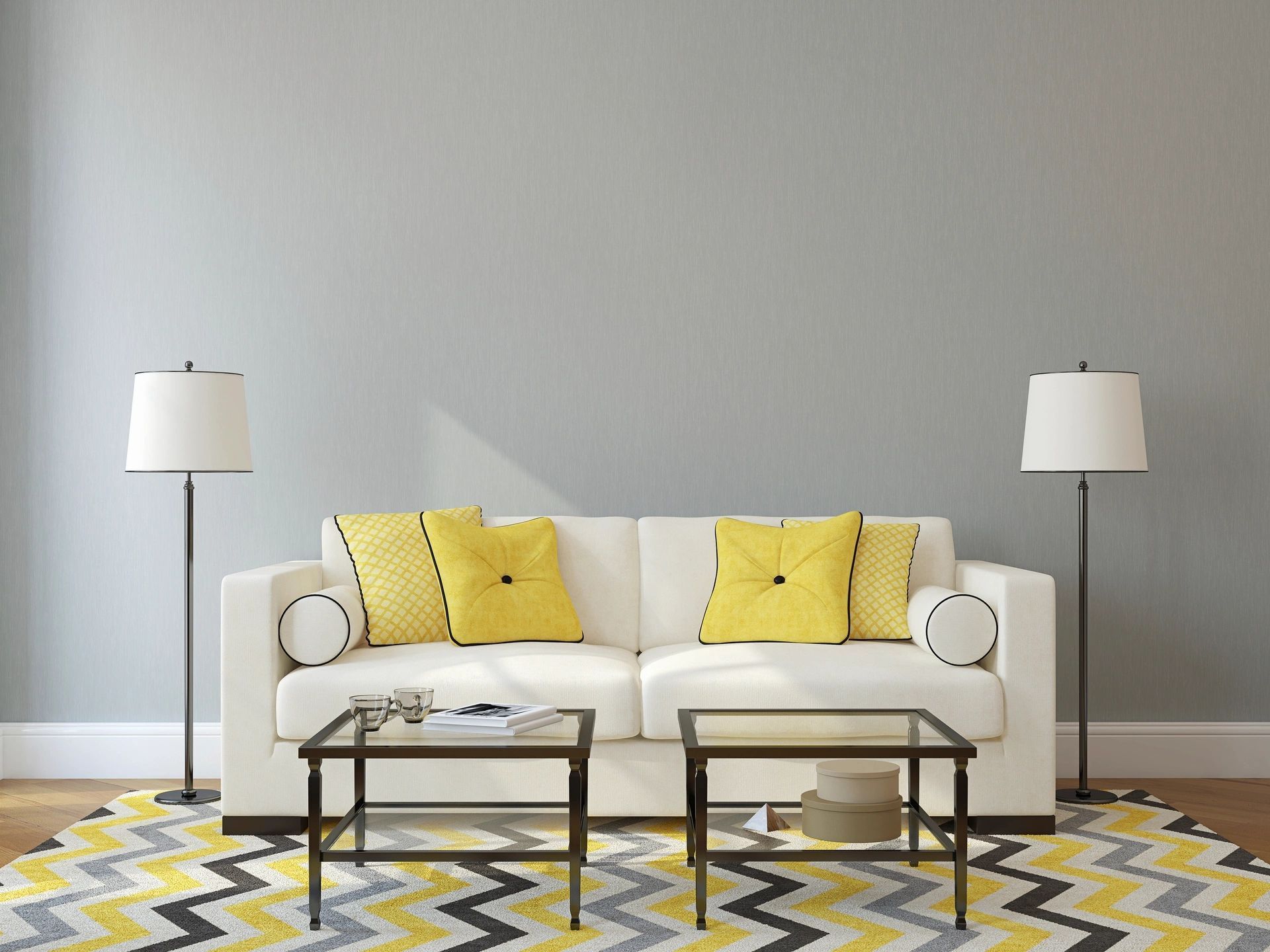 A living room with a white couch and yellow pillows