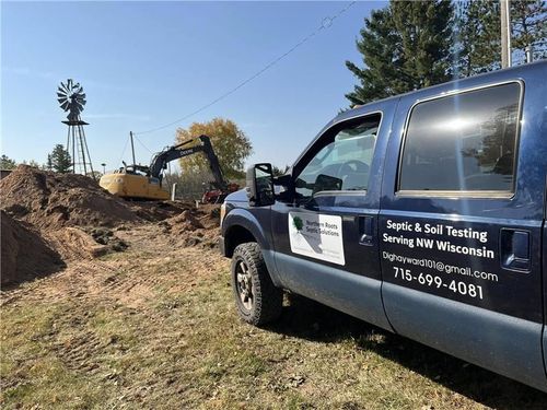Person examining soil samples on a white sheet, taking notes on a clipboard outdoors. Person examining soil samples on a white sheet, taking notes on a clipboard outdoors.