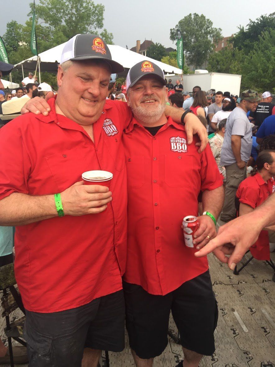 Two men standing next to each other with one wearing a shirt that says ' a few guys ' on it