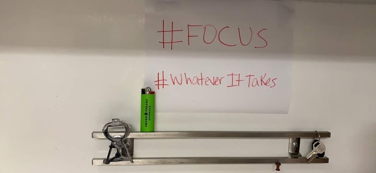 A shelf with a sign that says focus on it