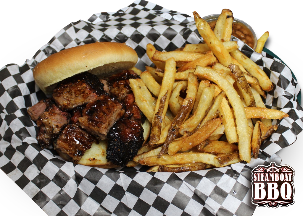 A sandwich and french fries in a basket on checkered paper