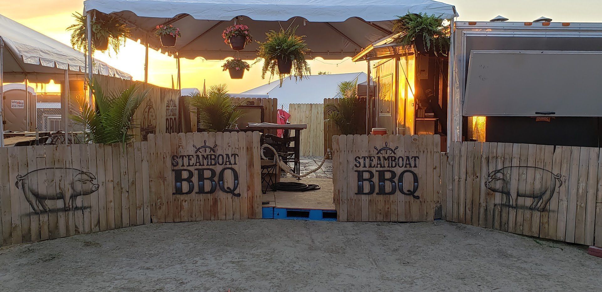 A wooden fence with bbq written on it