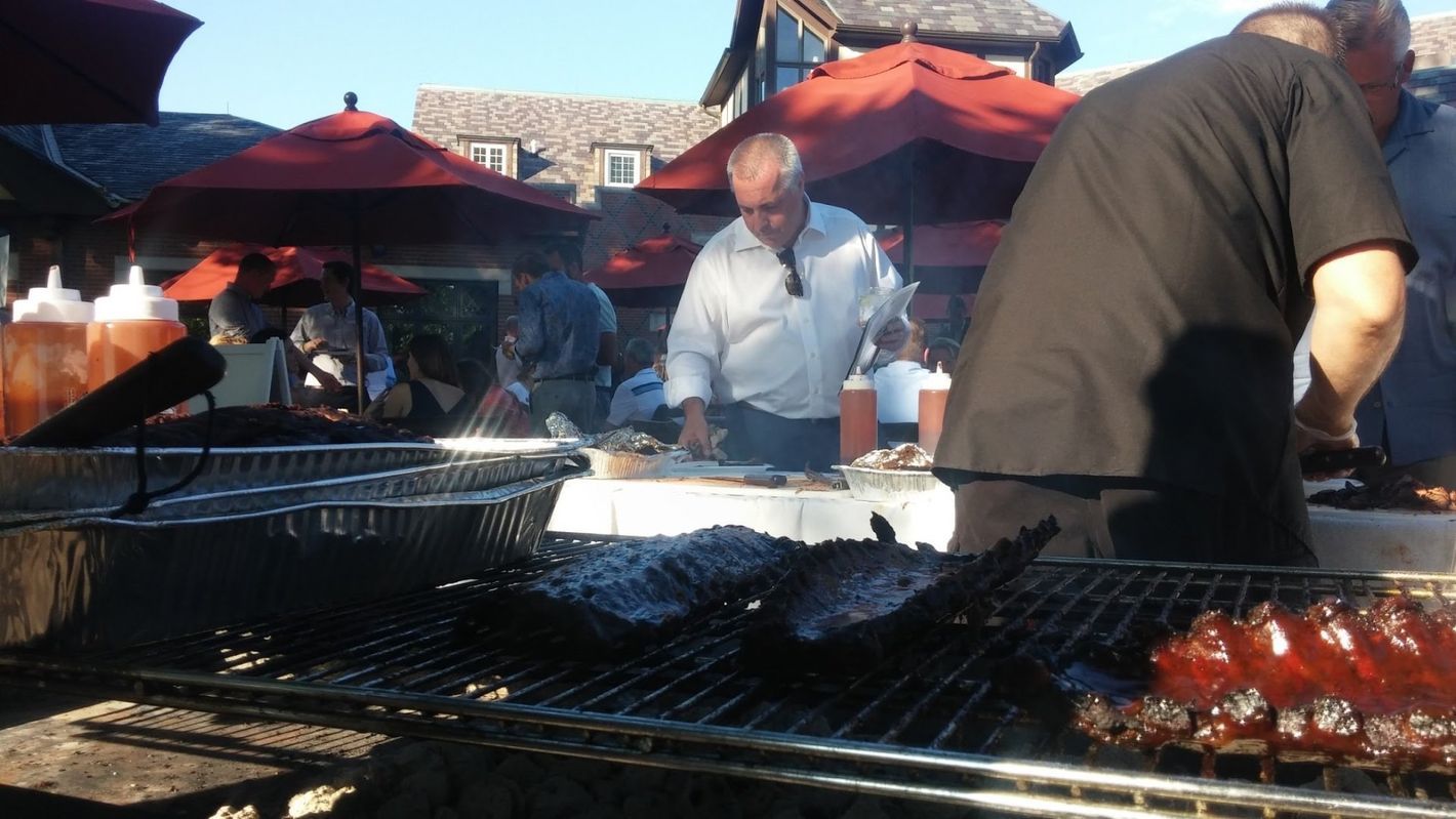 A group of people are cooking food on a grill