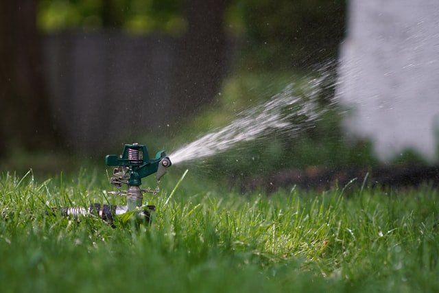 High Pressure Sprinkler Watering the Lawn | Green Garden Landscaping