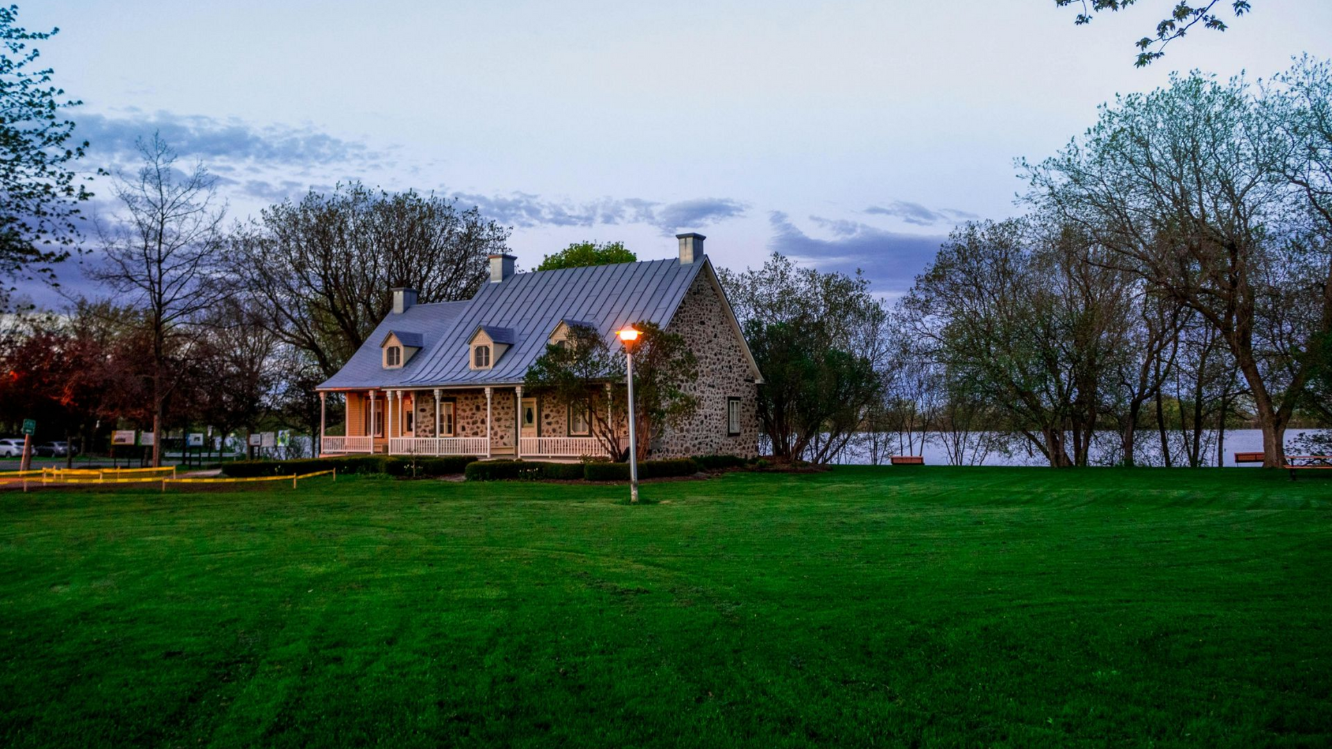 Healthy, green residential lawn at dusk in a North Carolina neighborhood, representing strong root growth from fall fertilization