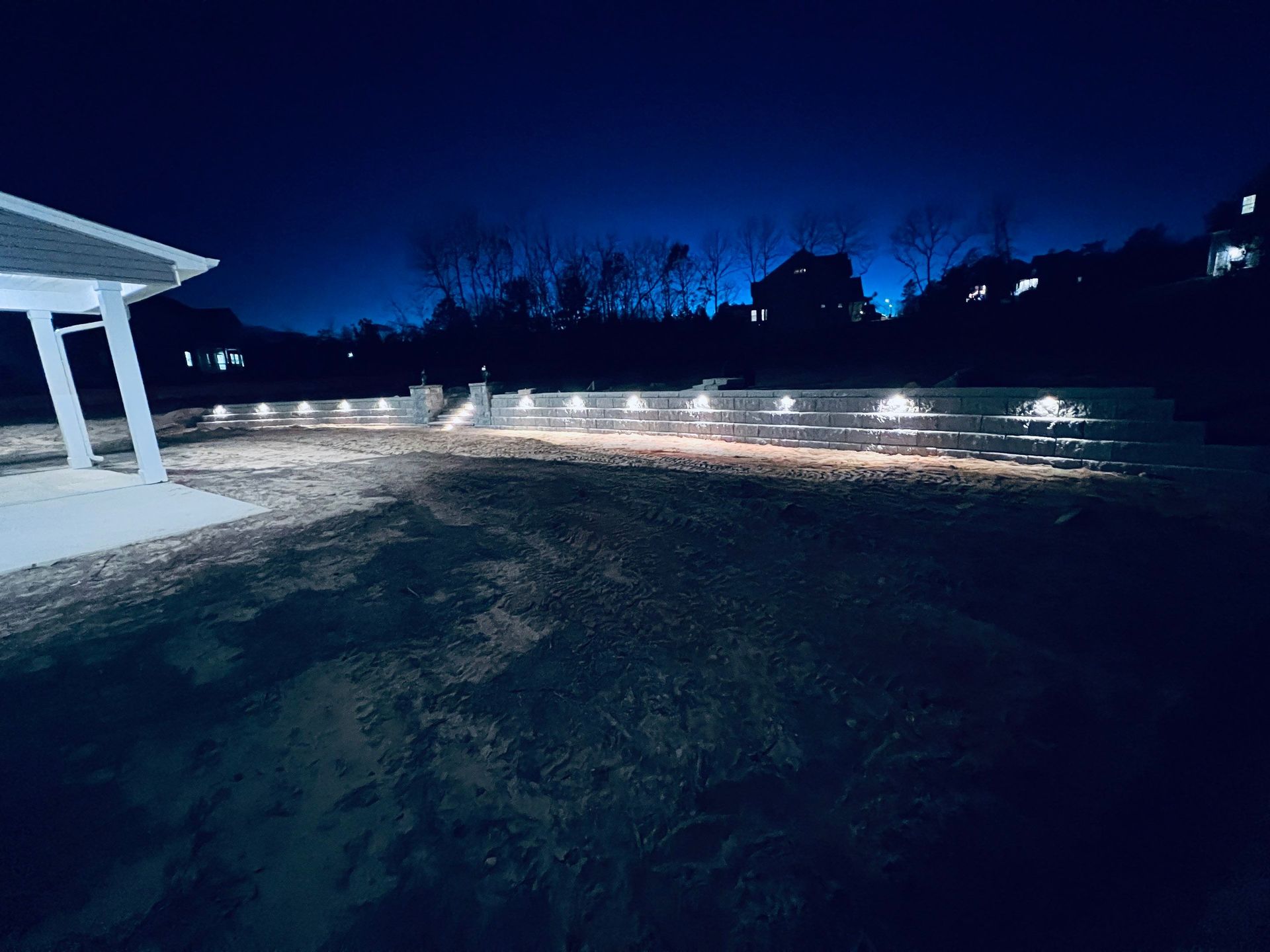 the backyard of a house is lit up at night .