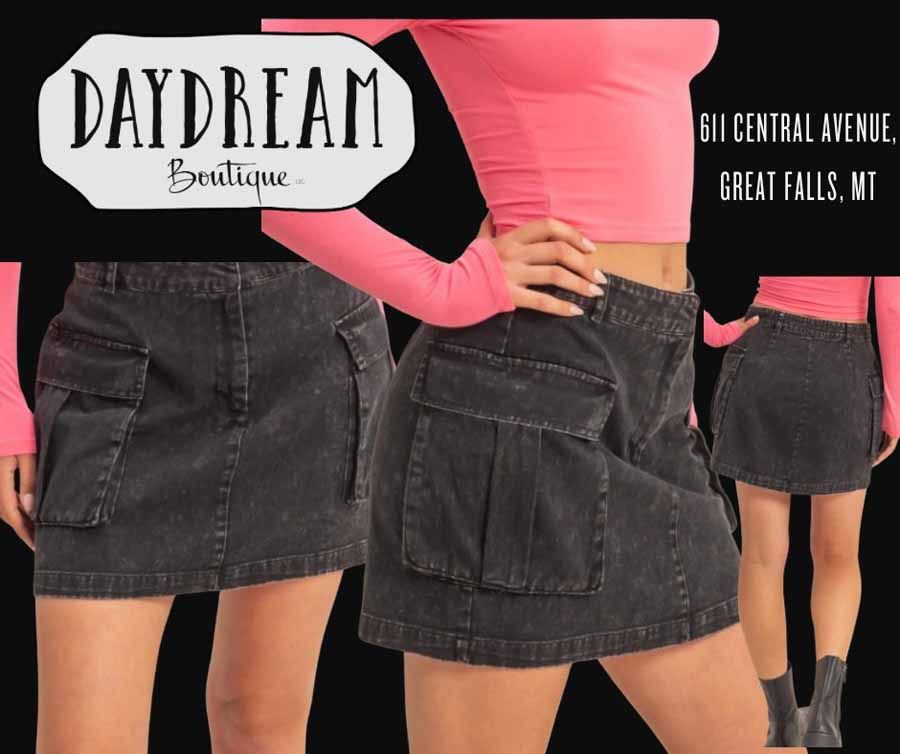 Black denim skirt ad with model in pink top. Daydream Boutique logo on the left, address on the right.