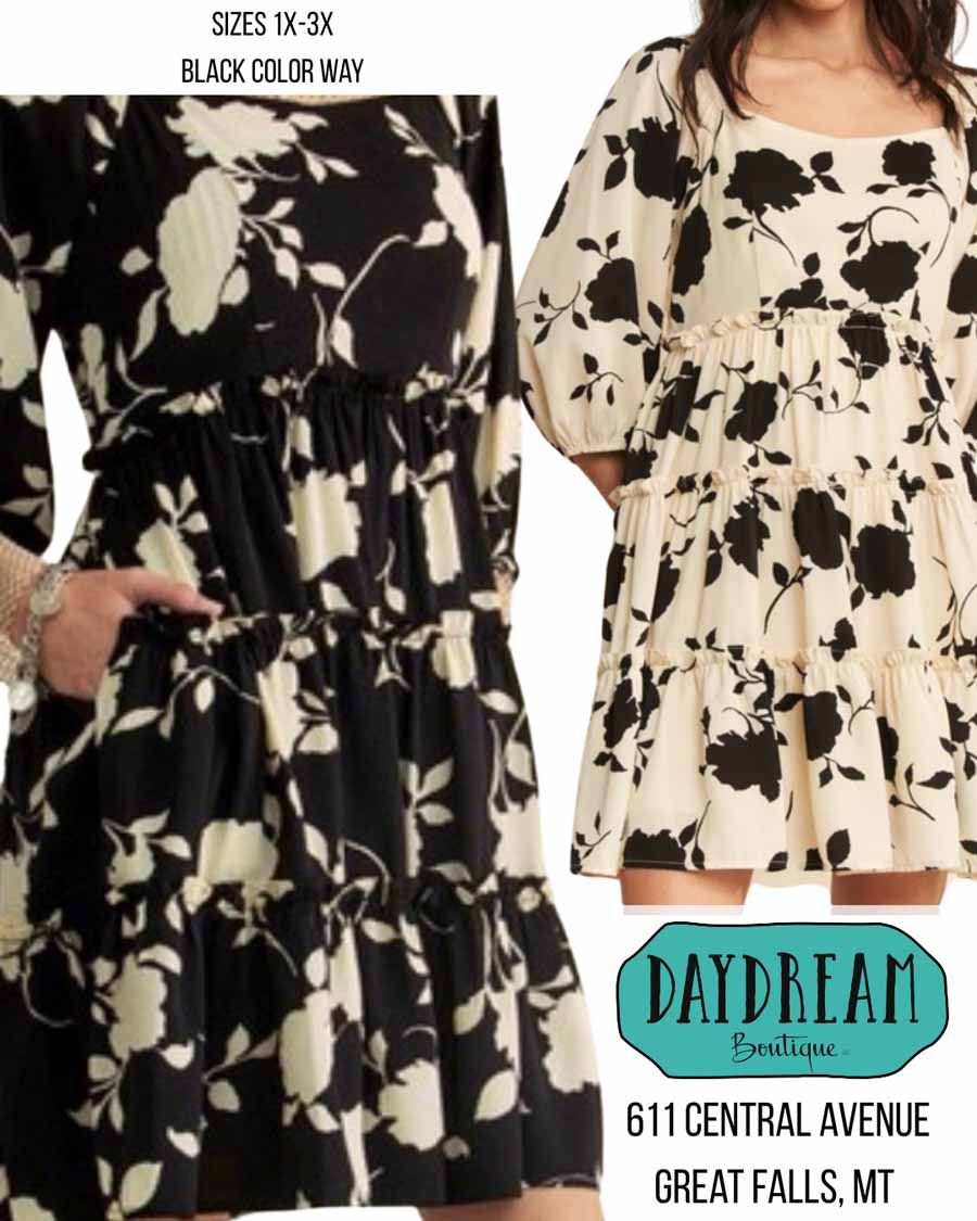 Black floral print dress with a gathered waist and tiered skirt.