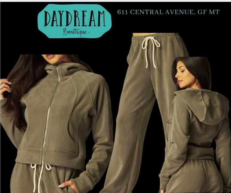 A woman's olive-green track suit from Daydream Boutique: jacket and pants.