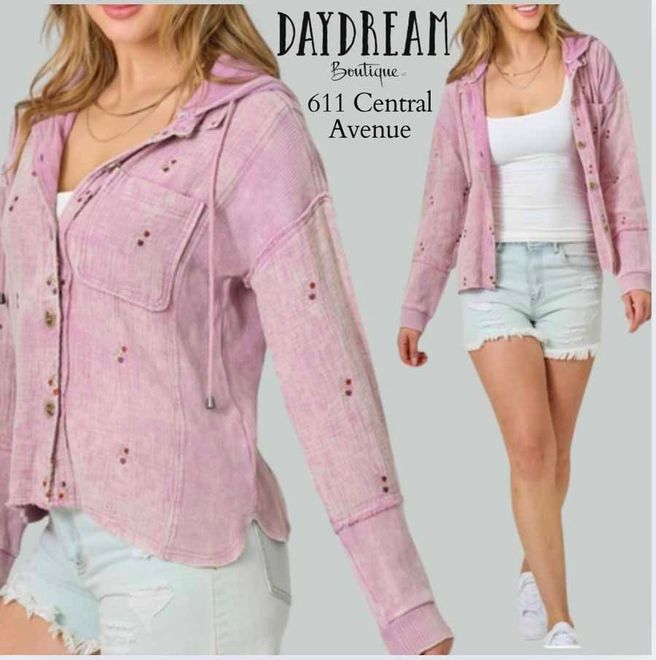 Woman in pink hooded jacket, shorts. Daydream Boutique, 611 Central Avenue.