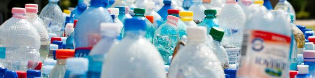 A bunch of plastic bottles are stacked on top of each other.