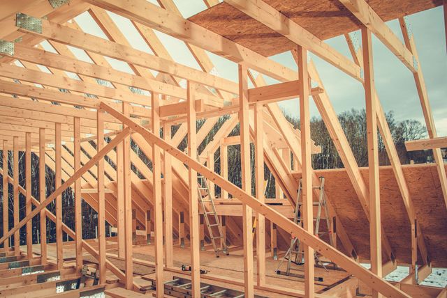 A house is being built with a lot of wooden beams.