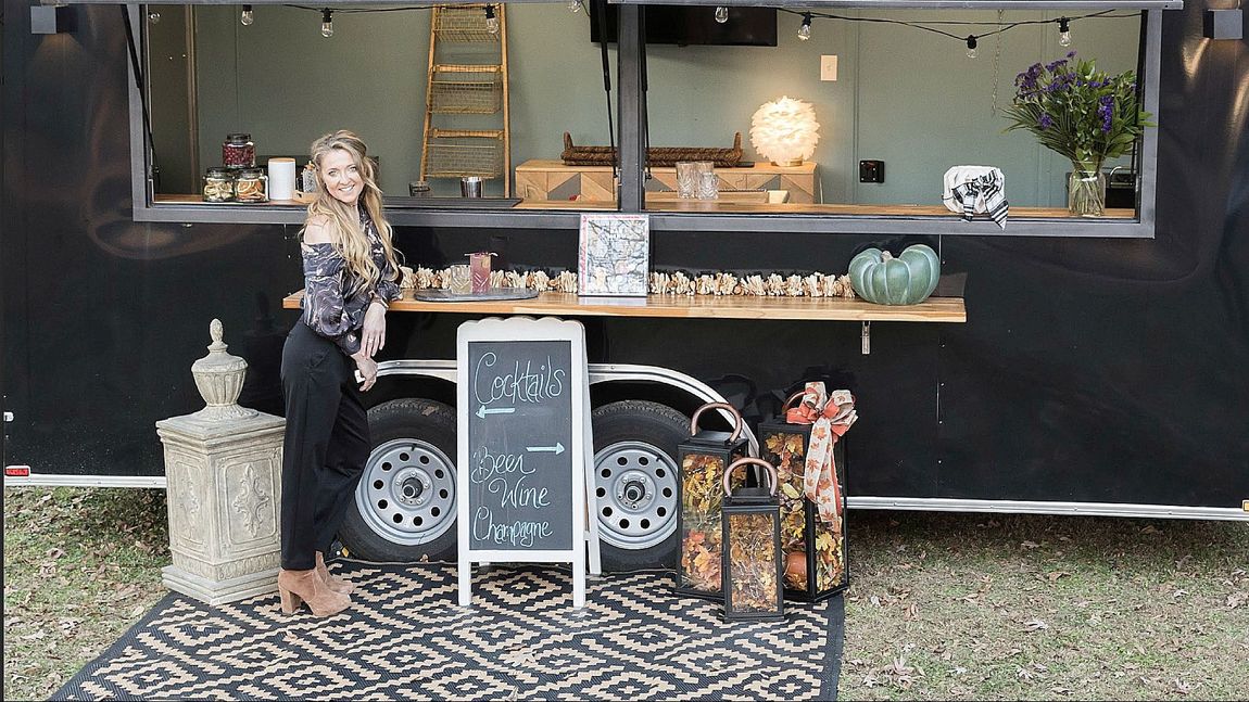 the owner is standing in front of a food truck