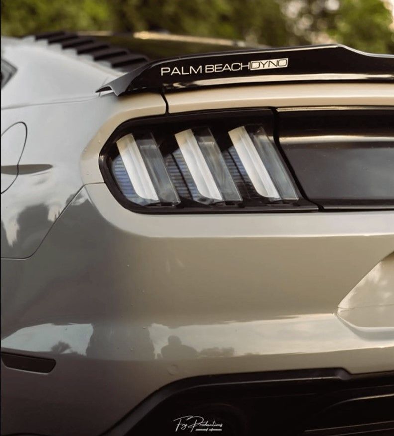 the rear end of a palm beach ford mustang