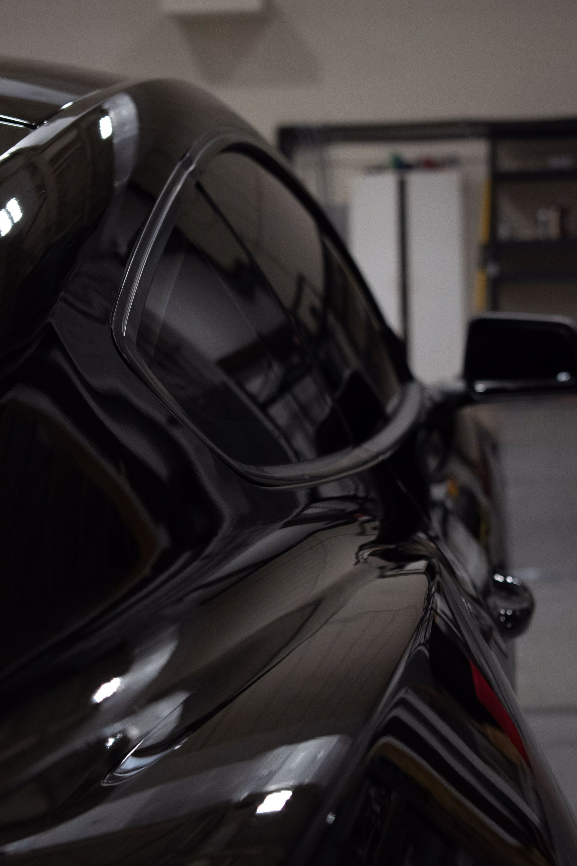a black sports car is parked in a garage