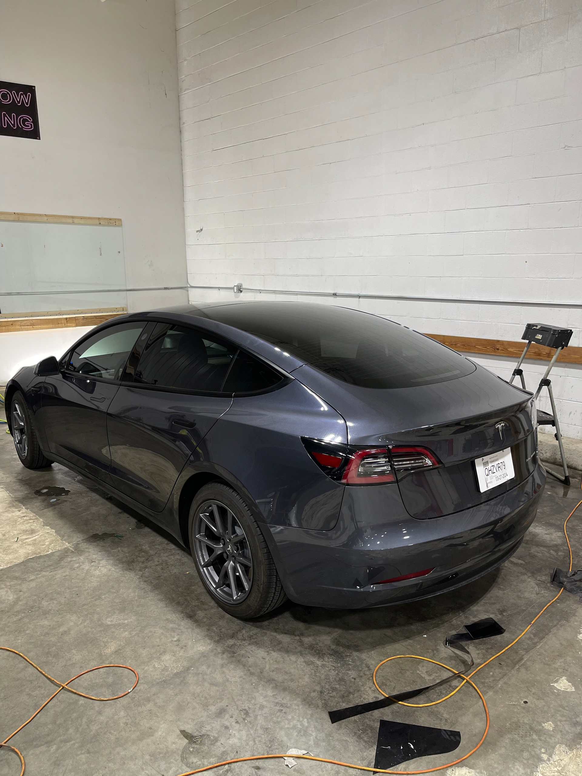 Tesla with tint applied to all side windows and the panoramic sunroof.