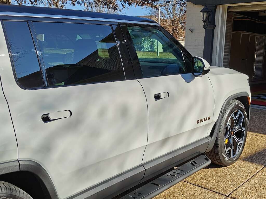 White Rivian truck with ceramic window tint applied by Eye Kandy Customs' window tinting services in Olive Branch, MS.