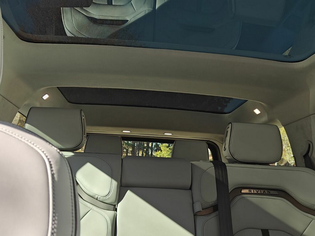 Interior view of a Rivian truck showcasing a tinted sunroof