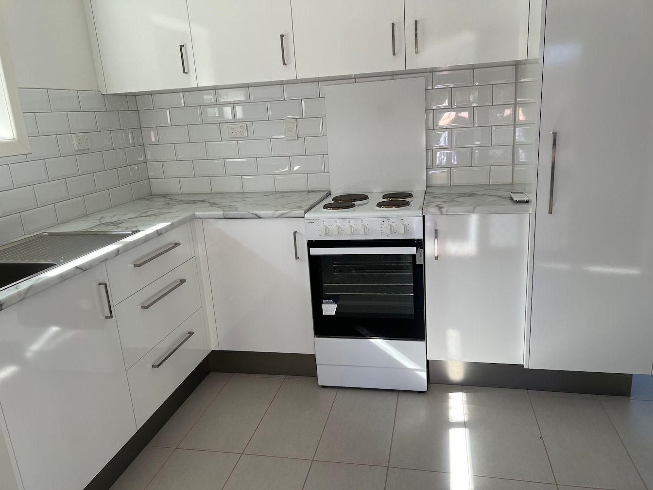 A Kitchen With White Cabinets And A Stove Top Oven — Miss Bright Cleaning Services In Mount Isa City, QLD