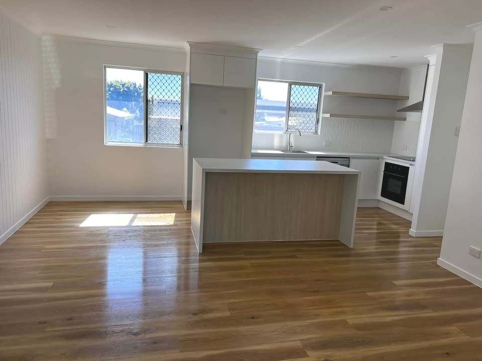 An Empty Room With a Carpeted Floor and a Window — Miss Bright Cleaning Services In Mount Isa City, QLD