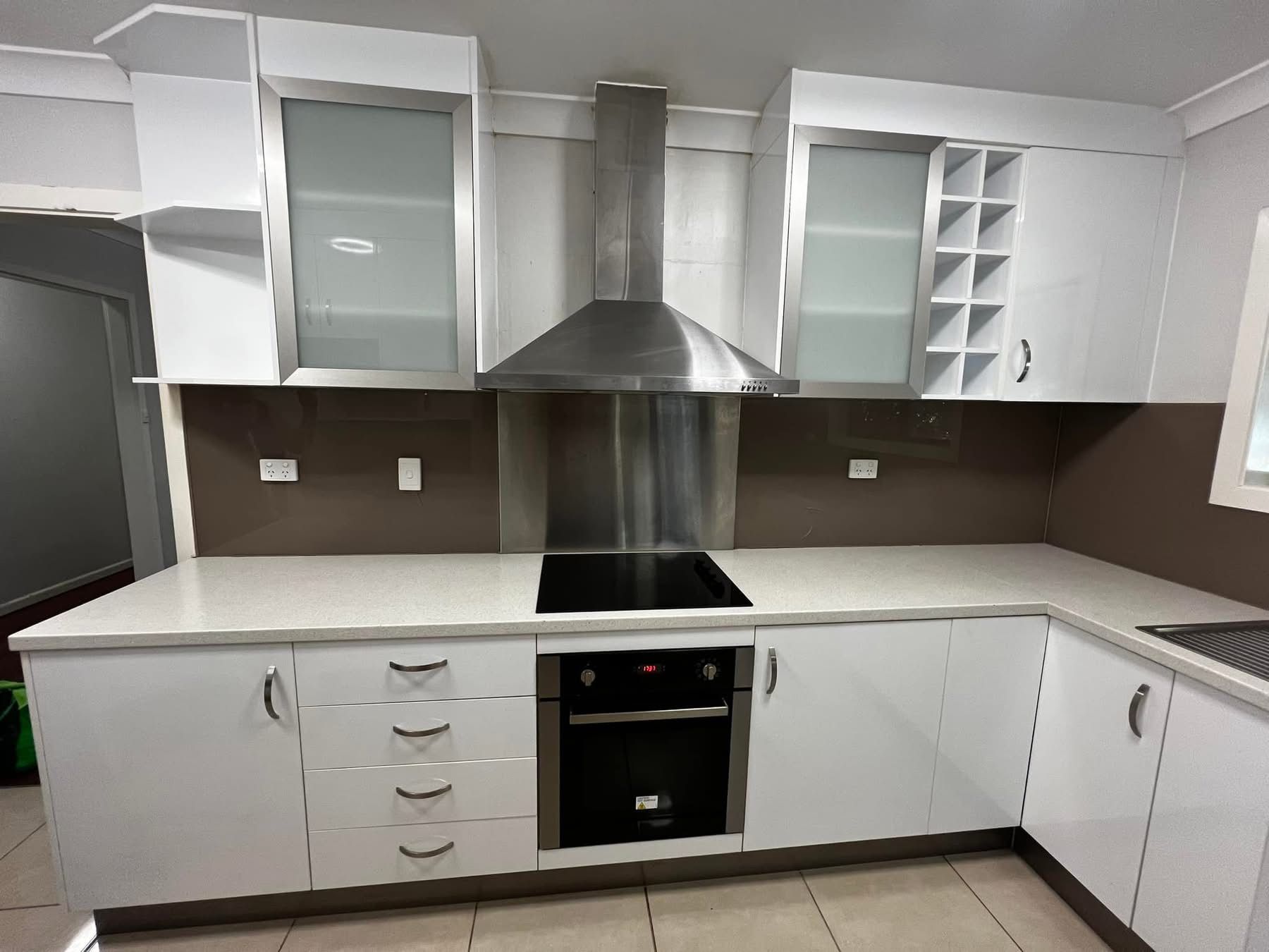 A Kitchen With White Cabinets And A Stove Top Oven — Miss Bright Cleaning Services In Mount Isa City, QLD